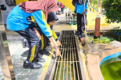Siswa bersama guru merawat ikan nila bersama. (istimewa)